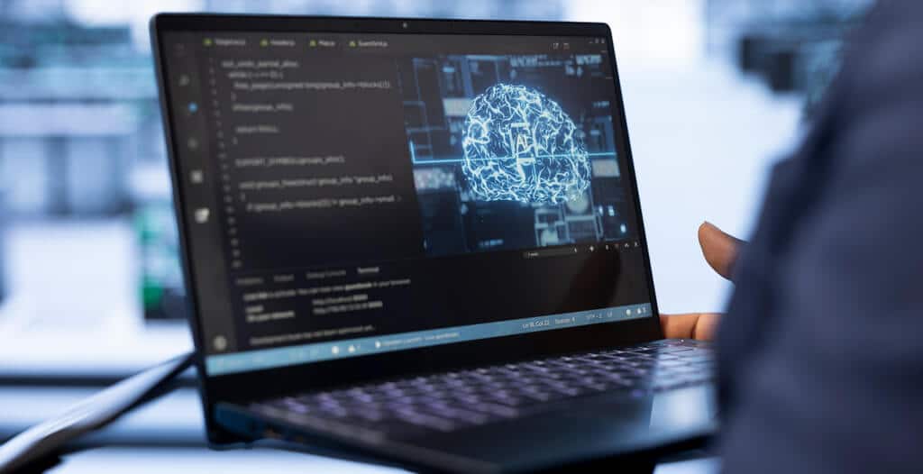 system administrator using laptop data center updating ai systems 1